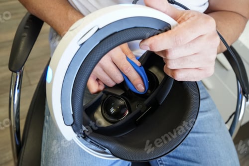 Preview: Man cleaning virtual reality glasses, clouse focus