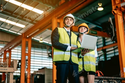 Preview: Factory manager and worker with safety helmet use laptop and corporated application