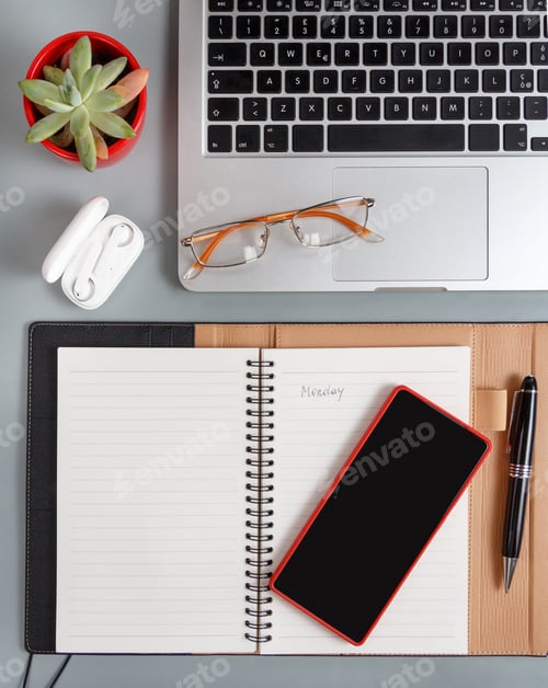 Preview: Opened agenda with handwritten MONDAY on a grey desk