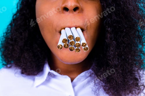 Preview: afro woman winning with addicted nicotine problems, stop smoking studio blue background