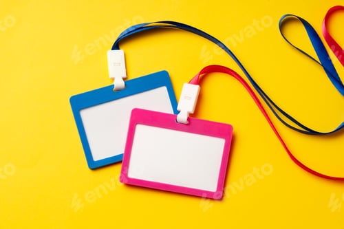 Preview: Colored blank nametags on strings on yellow background