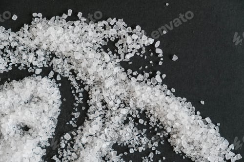 Preview: white crystals sea salt isolated on black background. sprinkled salt shakers of white salt. shot