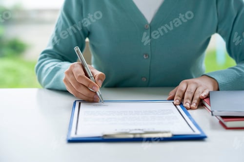 Preview: Signing Legal Documents with a Pen at Desk