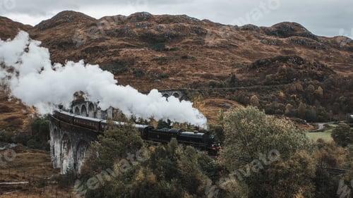 Preview: High angle shot of the famous historical Steam Train in Glenfinnan viaduct, Scotland