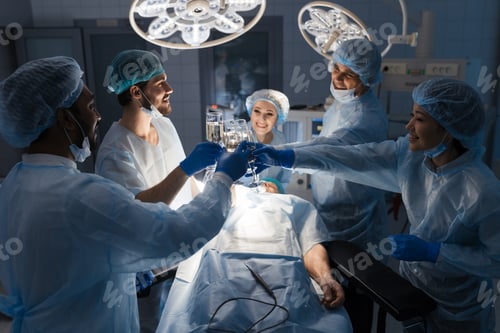 Preview: Diverse multiracial team of surgeons celebrate successful results of surgery