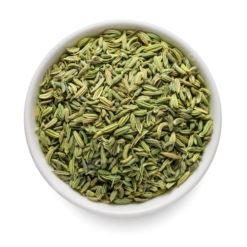 Preview: Fennel seeds in white bowl isolated on white. Top view.