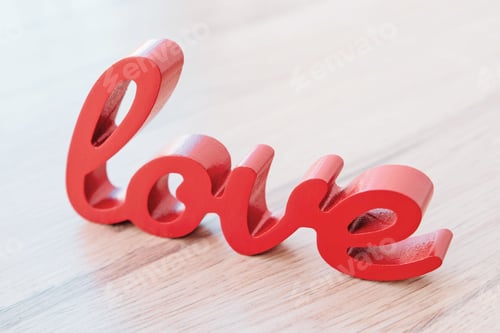 Preview: Red letters forming word love on wooden background.