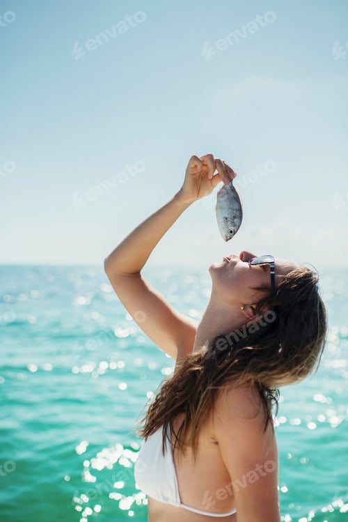 Preview: Woman enjoying the seaside sunshine