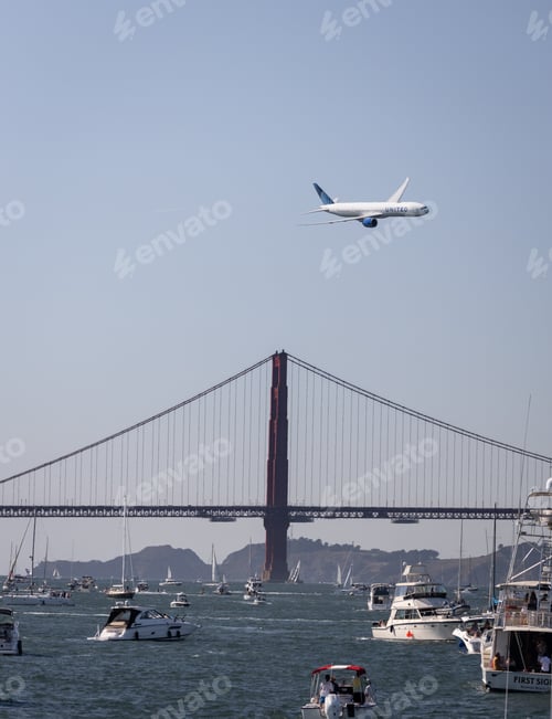 Preview: United Airlines Boeing 777 jet flying over the Golden Gate Bridge in San Francisco with boats