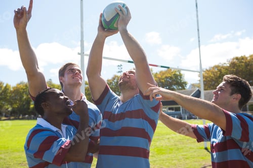 Preview: Rugby team enjoying victory while standing at field