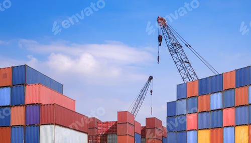 Preview: Pile of many cargo containers with 2 cranes in terminal shipping yard area against blue sky