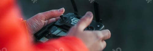 Preview: Hiker holding a drone controlling device