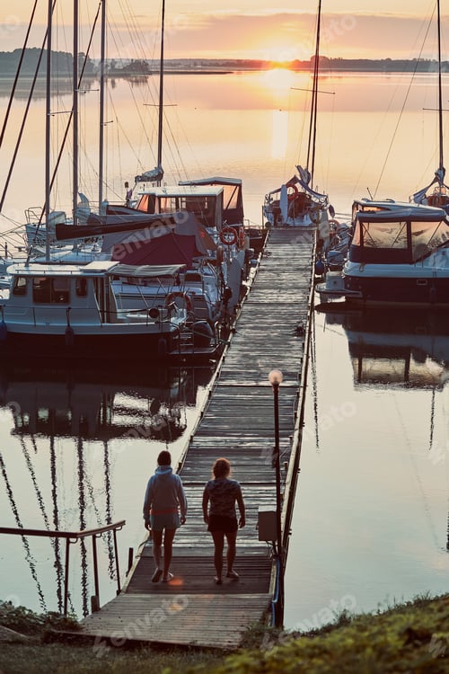 Preview: Yachts and boats moored in a harbour at sunrise. Candid people, real moments, authentic situations