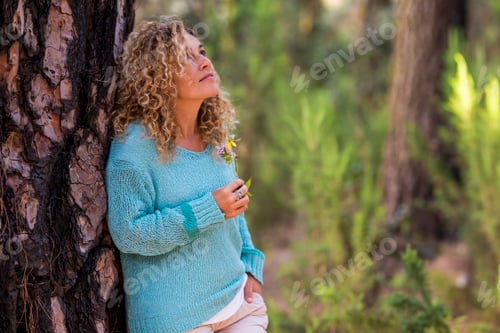 Preview: Woman with Curly Hair Relaxing in Green Forest