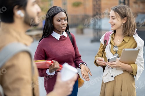 Preview: Female students with books walking and talking