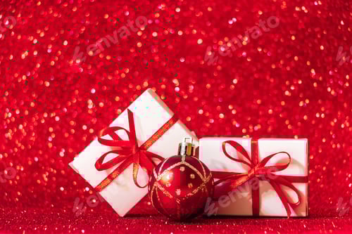 Preview: Gift boxes on red glittering background. Christmas concept, place for text.