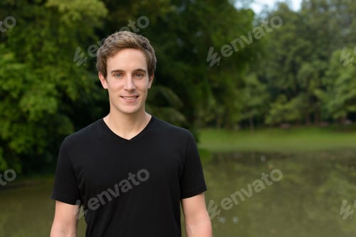 Preview: Portrait of young handsome man at the park
