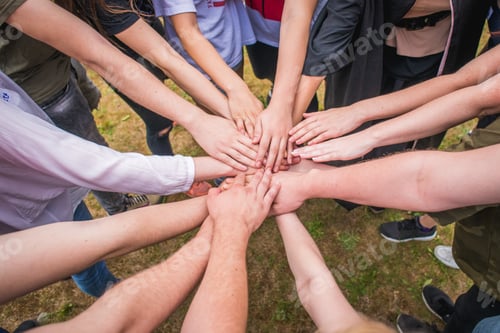Preview: High angle shot of unrecognizable adults and teens showing unity with their hands - teambuilding
