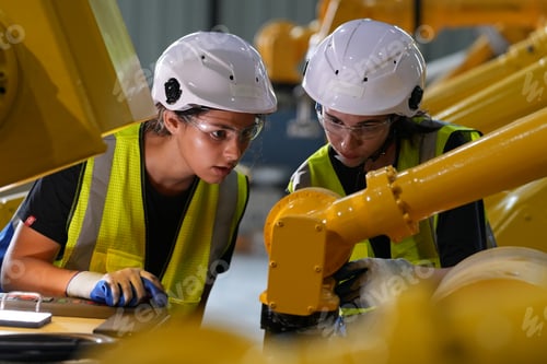 Preview: Robotics engineer working on maintenance of robotic arm in factory warehouse. Business technology.