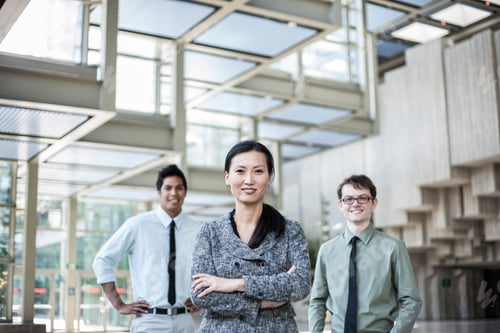 Preview: A portrait of a mixed race team of business people standing in the lobby area of a convention
