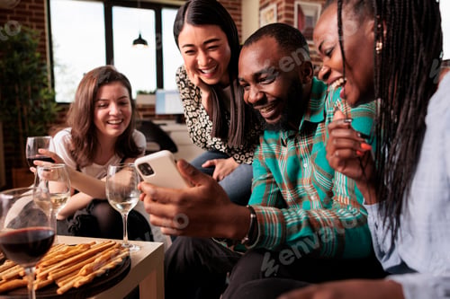 Preview: Multiple nationalities friends looking social media at smartphone