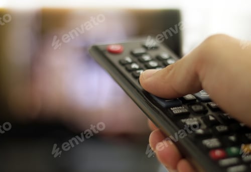 Preview: Closeup shot of a man holding a black remote control
