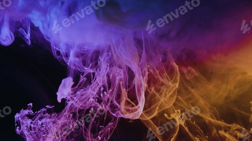 Preview: Closeup of the abstract colorful paint being dropped in the water