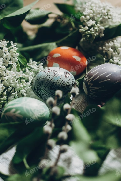 Preview: easter eggs with lilac flowers on rustic background
