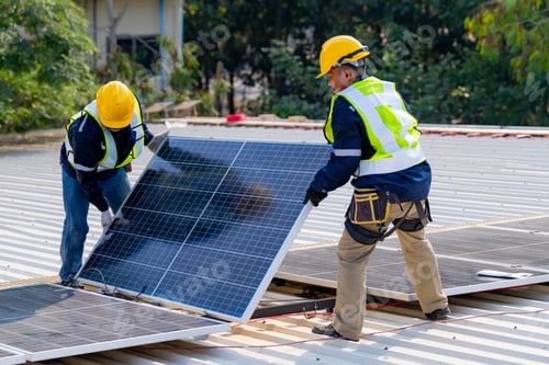 Preview: workers installing solar panels, for efficient energy on rooftop