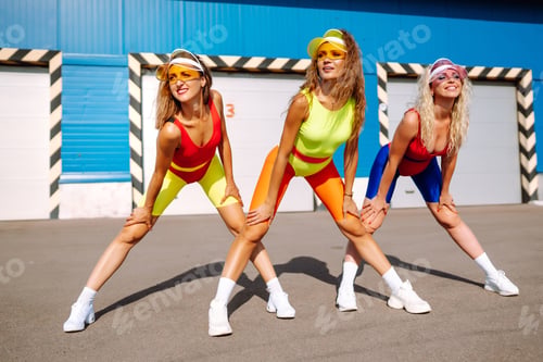 Preview: Young dancers in colorful swimsuits are dancing in morning. ?oncept of sports, fitness Active sport.