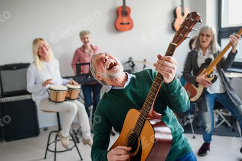 Preview: Group of senior people playing musical instruments indoors in band