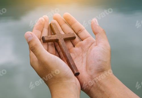 Preview: the man praying with cross in river background, Symbol of Faith.