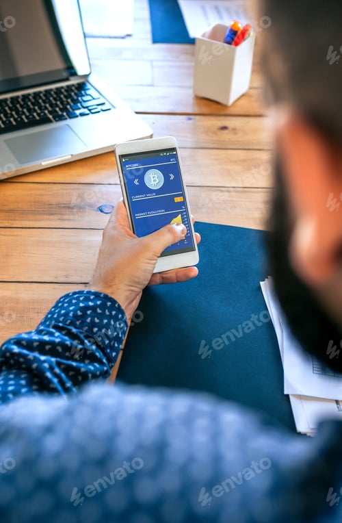 Preview: Businessman looking mobile with bitcoins information