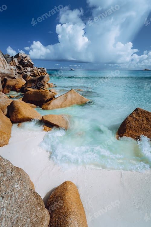 Preview: Beautifully shaped granite boulders and blue lagoon at Grand Anse beach, La Digue island, Seychelles