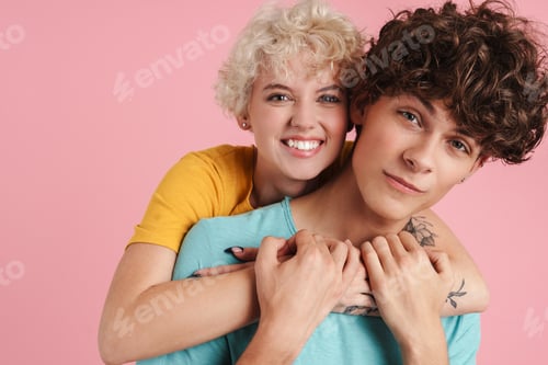 Preview: Happy young couple of teenagers standing isolated