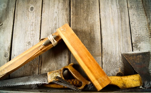 Preview: Many old tools ( axe, corner and others) on a wooden shelf.