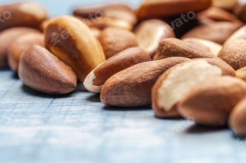 Preview: Brazil nuts resting on a textured blue surface