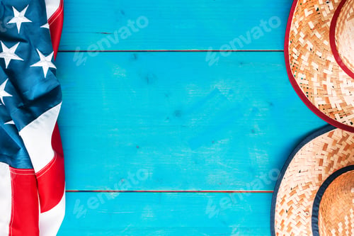 Preview: Two straw hats and american flag on wooden board as copy space