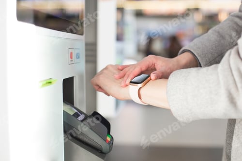 Preview: Woman paying at cafe with smart watch wirelessly on easy POS terminal