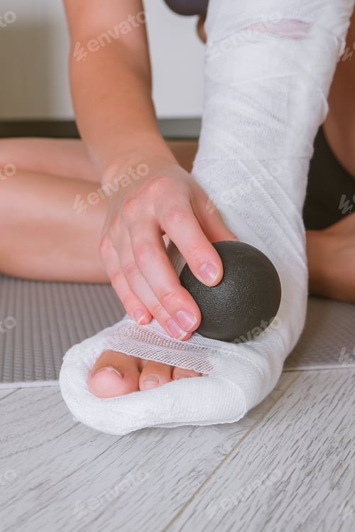 Preview: woman with a leg injury in a cast restores muscle function and rehabilitation with mfr massage, myof