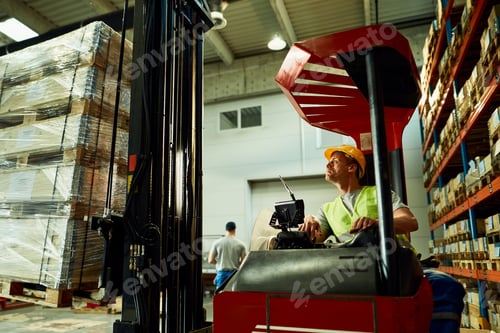 Preview: Forklift operator loading cargo while working in a warehouse.