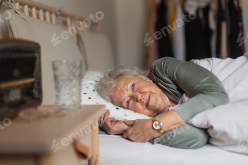 Preview: Senior woman sleeping in her bed alone.