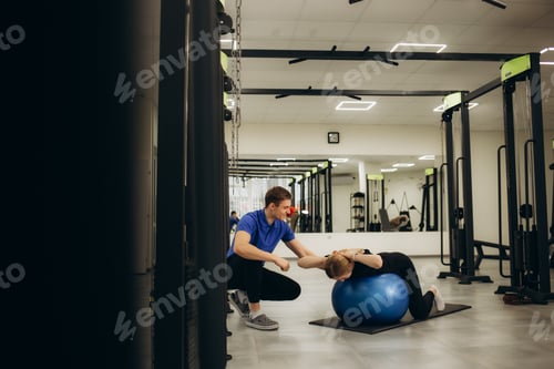 Preview: Woman Exercising with Assistance in a Gym