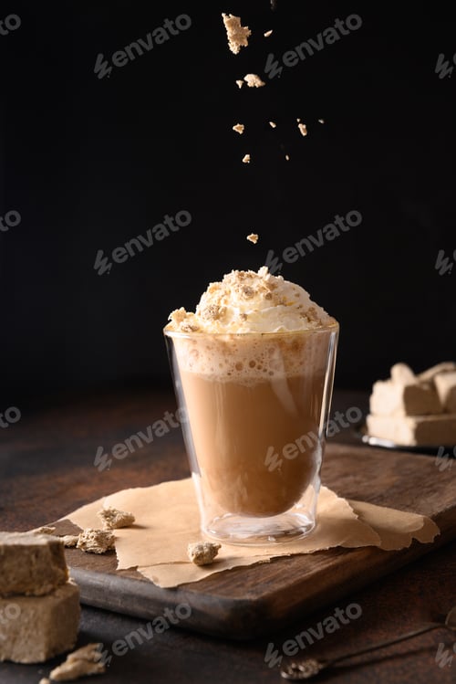 Preview: Sprinkles halawa in trendy recipe coffee latte with halva in modern glass cup on dark background.