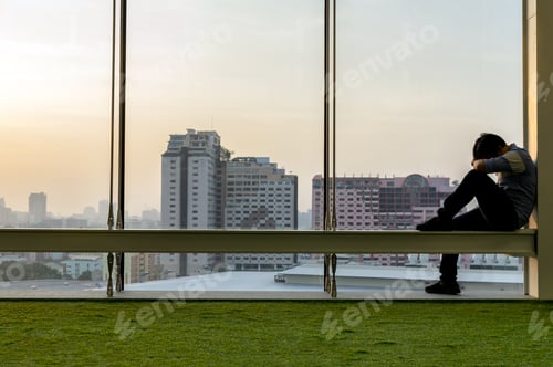 Preview: Sad businessman sitting head in hands on the the modern creative Office,
