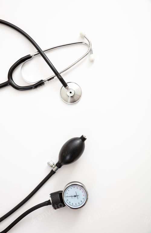 Preview: Medical stethoscope and sphygmomanometer on white background, top view.