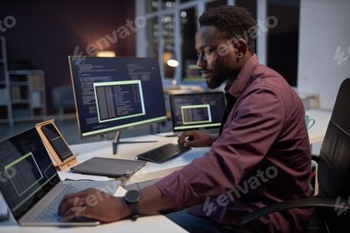Preview: Programmer concentrating on his online work on computers