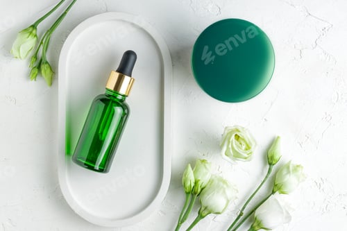 Preview: Natural cosmetics set. Moisturizing cream and serum in dropper bottle on ceramic tray on a table.