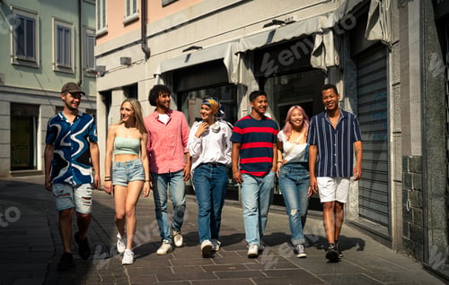 Preview: Group of multiethnic teenagers spending time outdoor and having fun