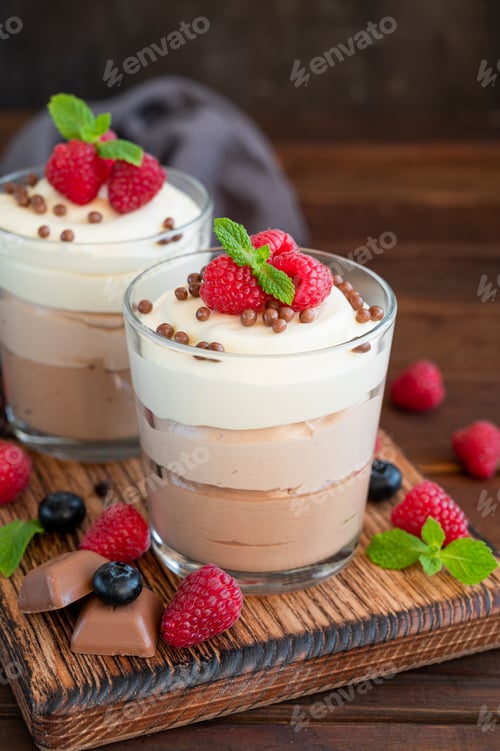 Preview: Dessert three chocolate in a glass jar with fresh berries on top. Copy space.